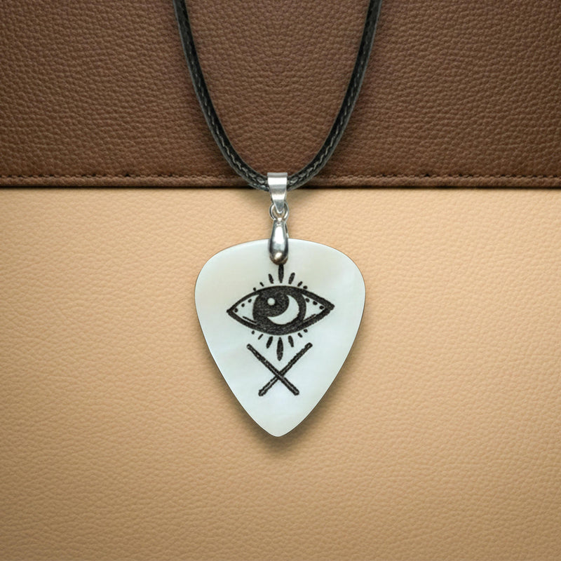 White bone guitar pick necklace engraved with a mystic eye and crossed lines symbol.