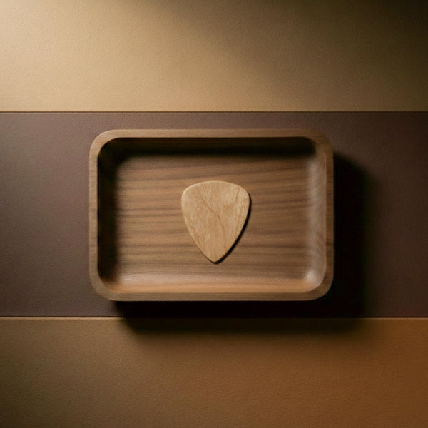 Light colored natural maple wood guitar pick with visible grain.
