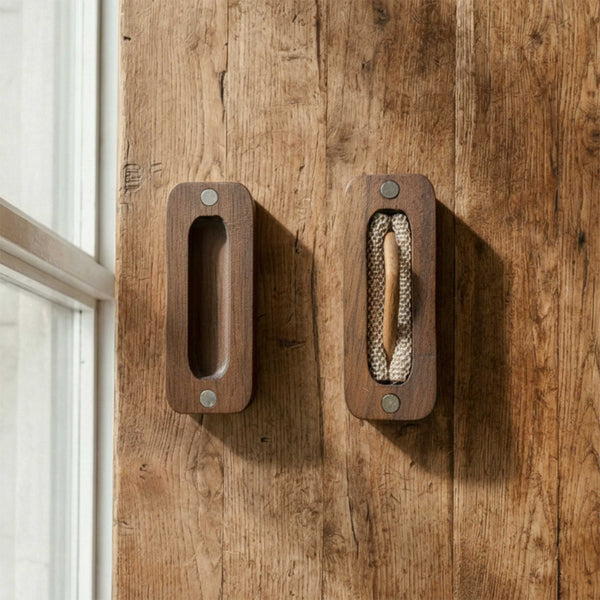 Minimalist rectangular wooden guitar pick box with rounded edges and a sliding lid mechanism. Shows internal compartment layout on a wooden background.