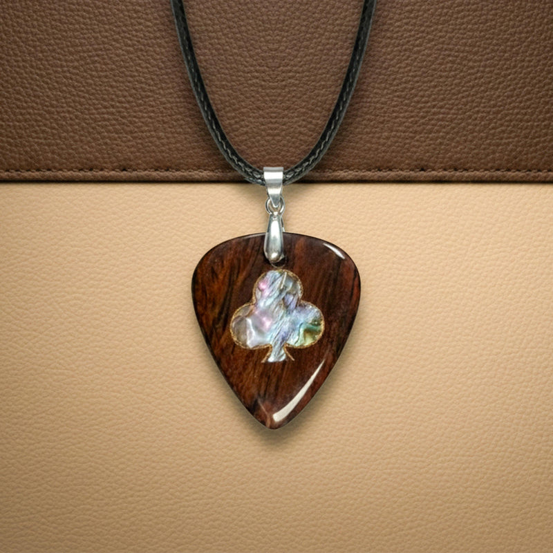 Wooden guitar pick necklace with an abalone shell inlay shaped like a club card suit (or clover). Lucky charm style pendant for musicians.