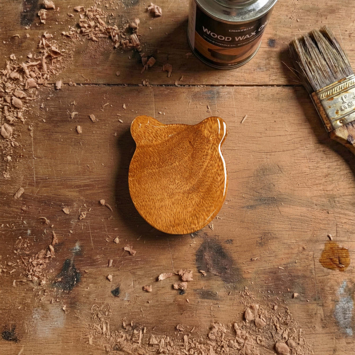 Bear head shaped wooden box with rounded ears, cute accessory for storing guitar picks, warm golden wood color.