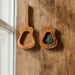 Wooden guitar pick case shaped like an acoustic guitar body and neck. Open case reveals a black pick with a musical note symbol. Features magnetic closure.