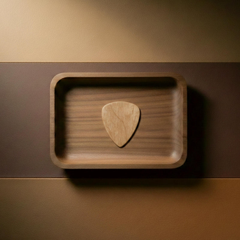 Light colored natural maple wood guitar pick with visible grain.