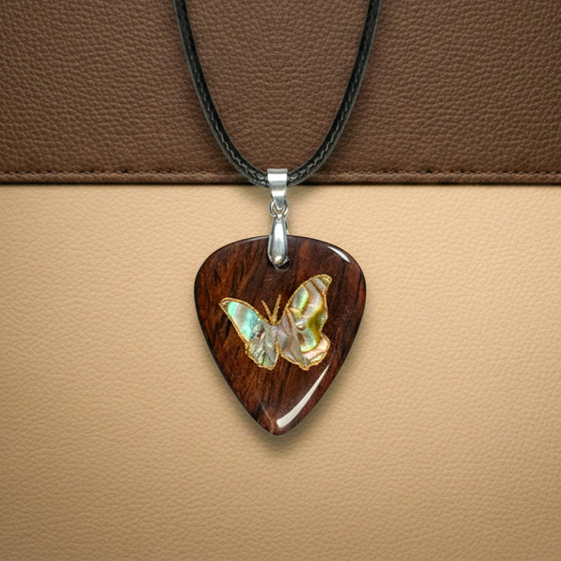 Exotic wood guitar pick necklace with a detailed abalone shell butterfly inlay design.