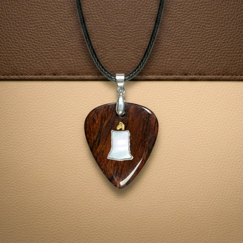 Wooden guitar pick necklace featuring a white mother-of-pearl inlay shaped like a lit candle with a gold flame. Unique accessory for guitarists.